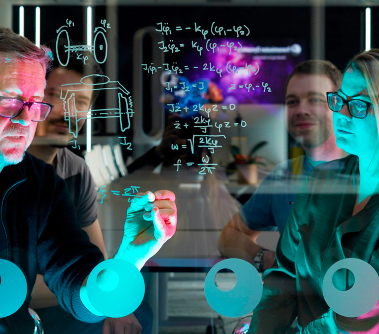 Transmission Dynamics staff working on engineering calculations