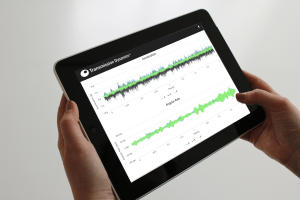A user shown accessing the GDN® Data Analysis AI Portal using a tablet