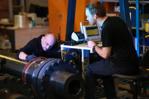 Two engineers working on a gearbox diagnostic project