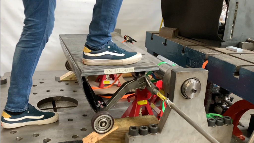 Testing mechanical condition of an escalator step.